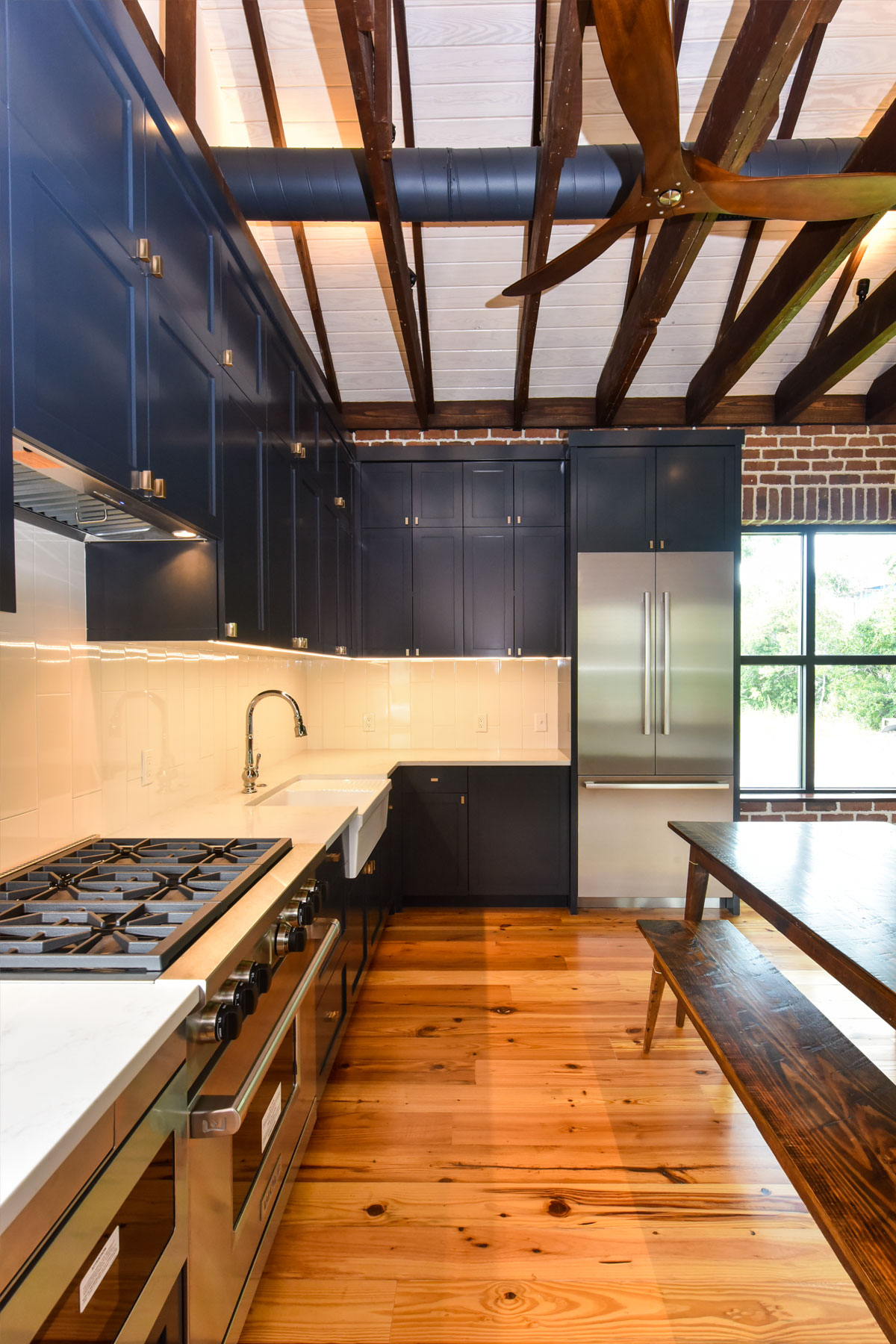 Dark navy cabinets in modern coastal kitchen design