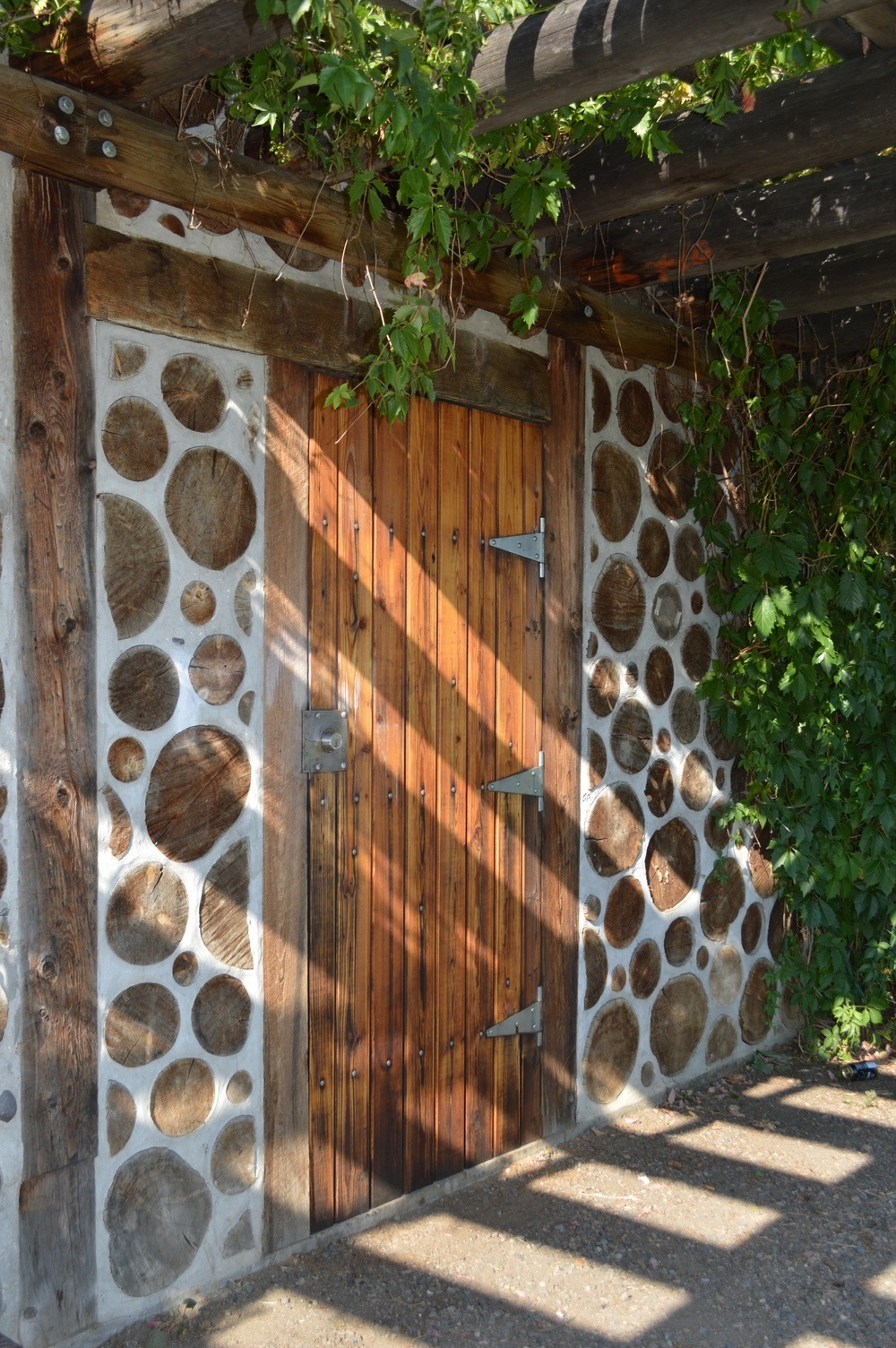 Detail of Cordwood Wall at the Community Garden
