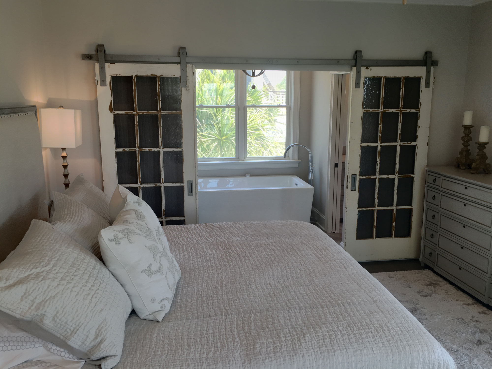 Salvaged doors open to master bath addition on balcony