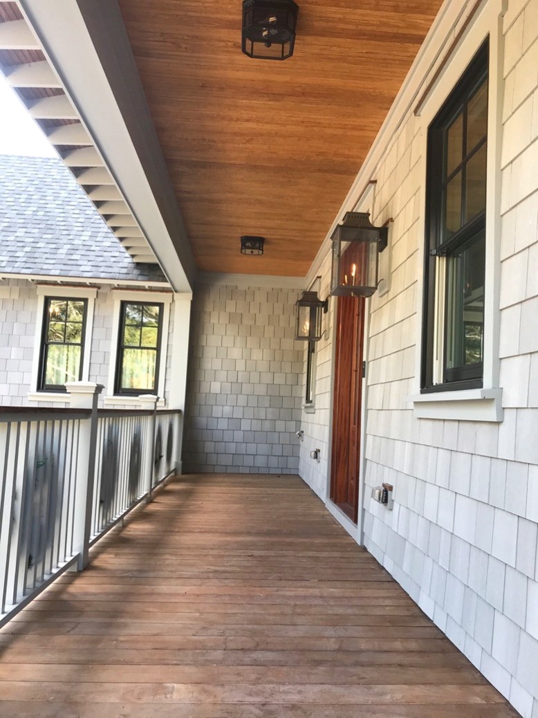 Front porch with wood ceiling, gray shake exterior