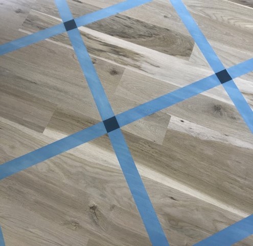 Detail of painted wood floor with square pattern detail