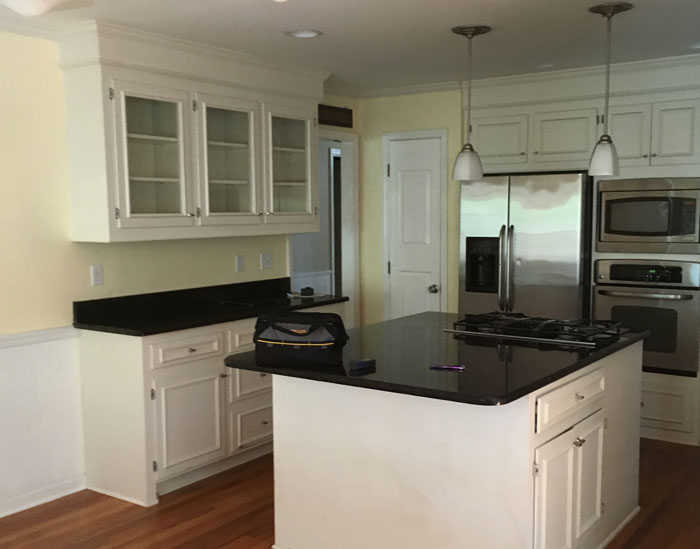Kitchen renovation from white cabinets and black granite