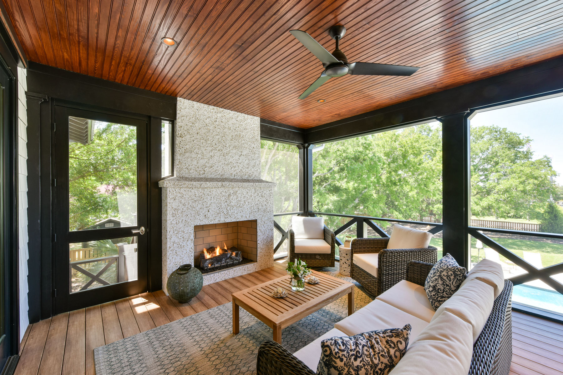 Tabby covered fireplace on screened porch
