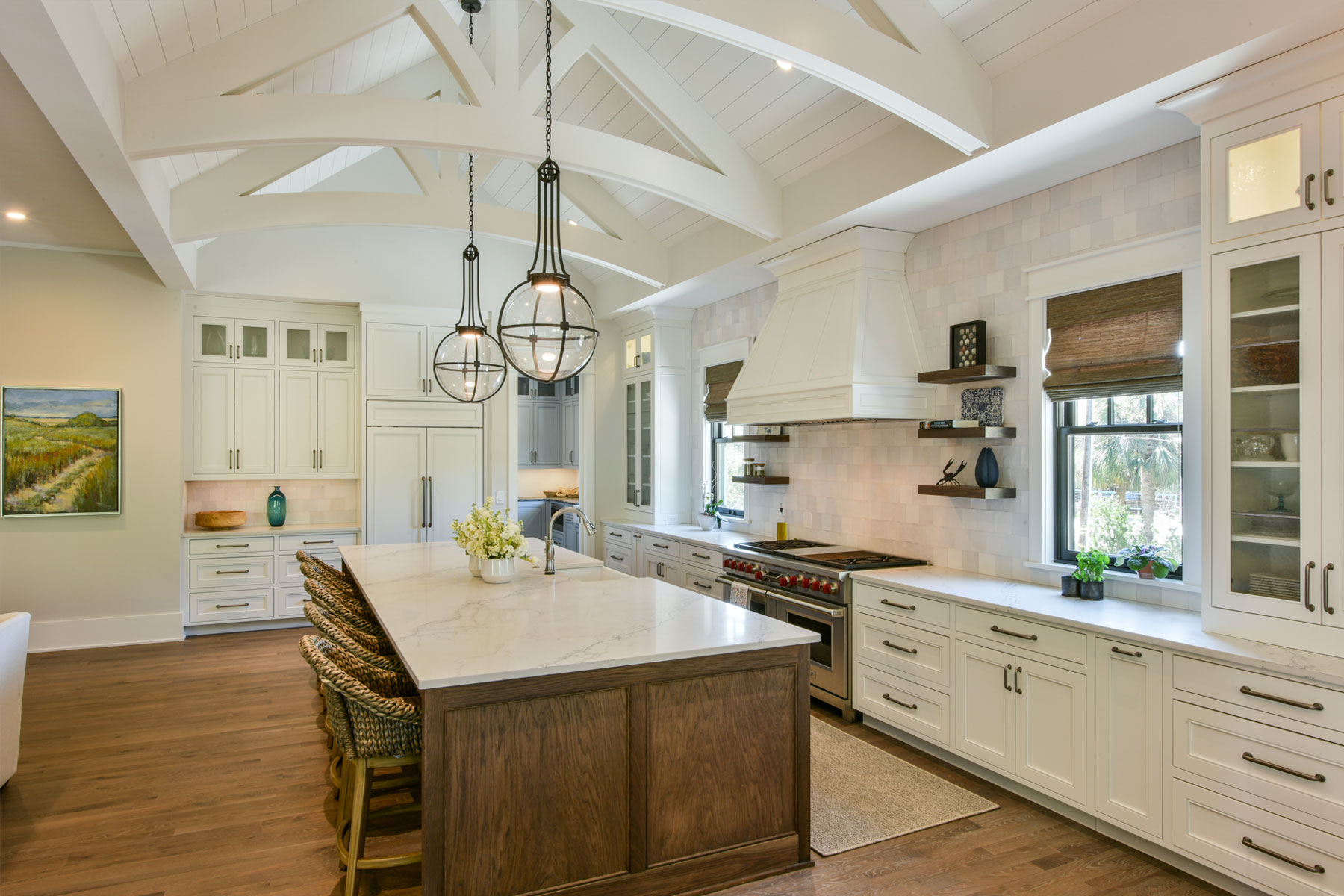 Coastal kitcehn with white cabinets and exposed trusses