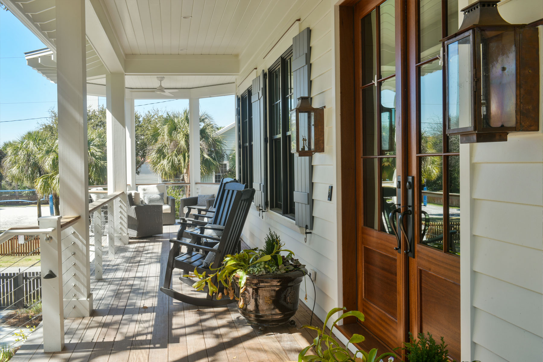 Coastal style, covered front porch with adjacent seating area