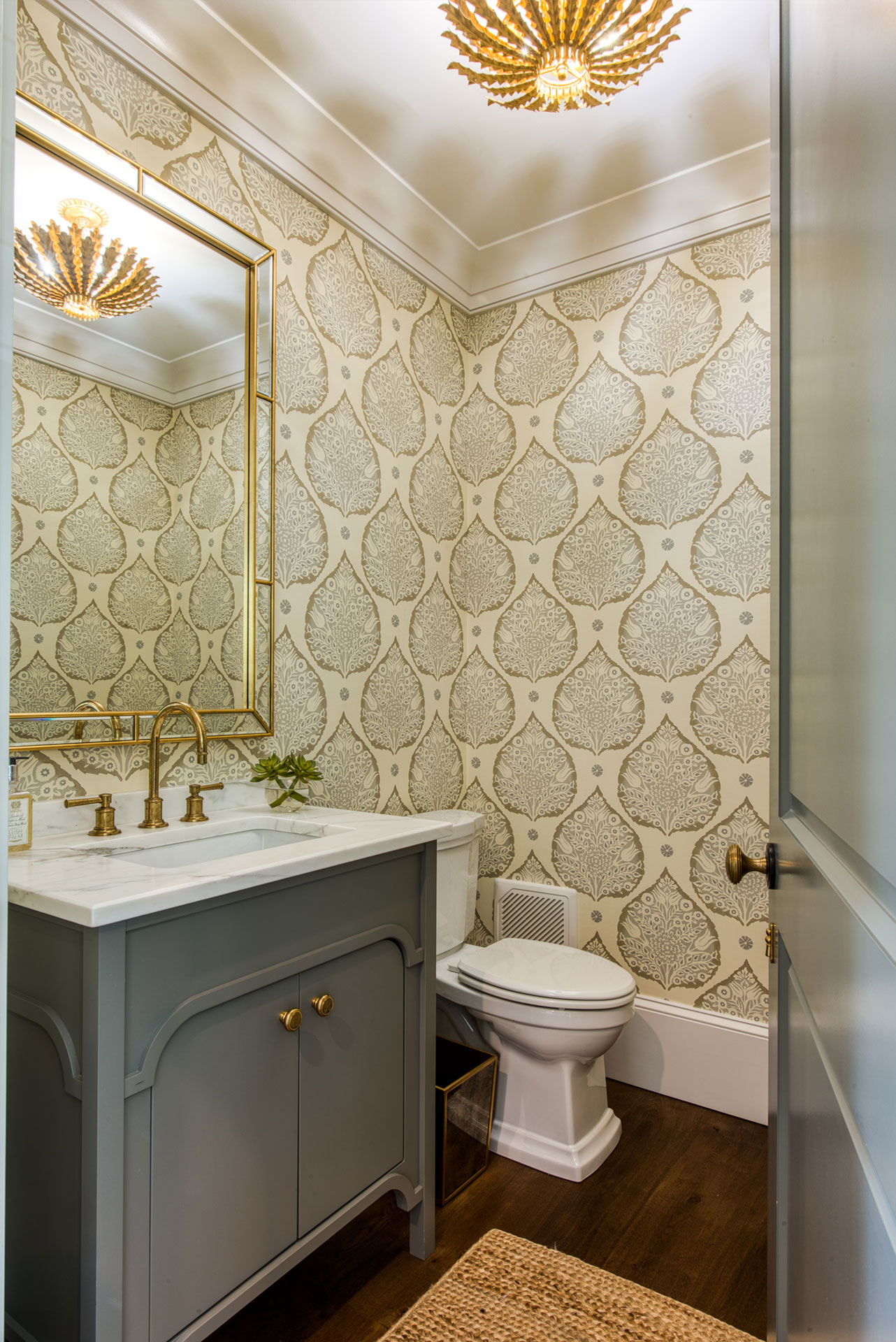 Powder room with bold wallpaper