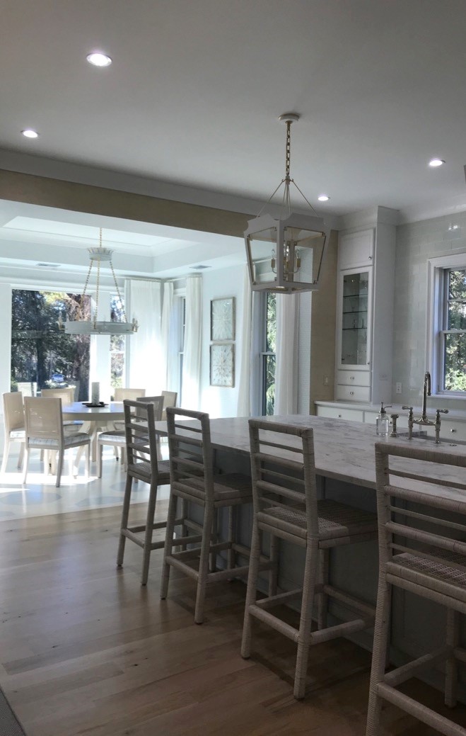 Kitchen area open to light filled dining room in Coastal Kiawah home