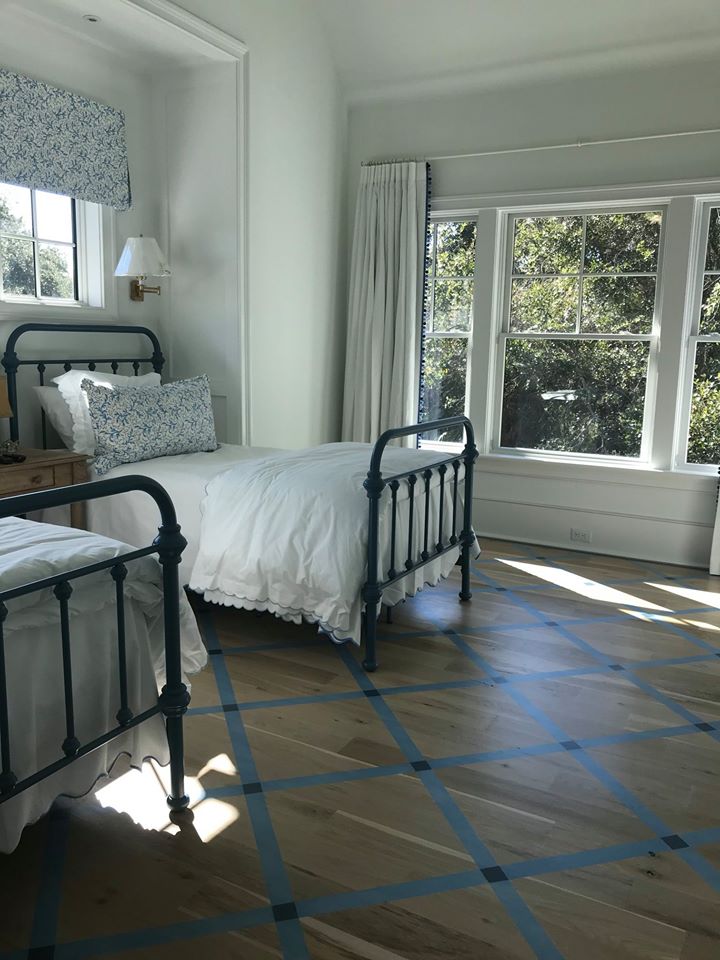 Guest floor with twin beds and painted natural wood floor