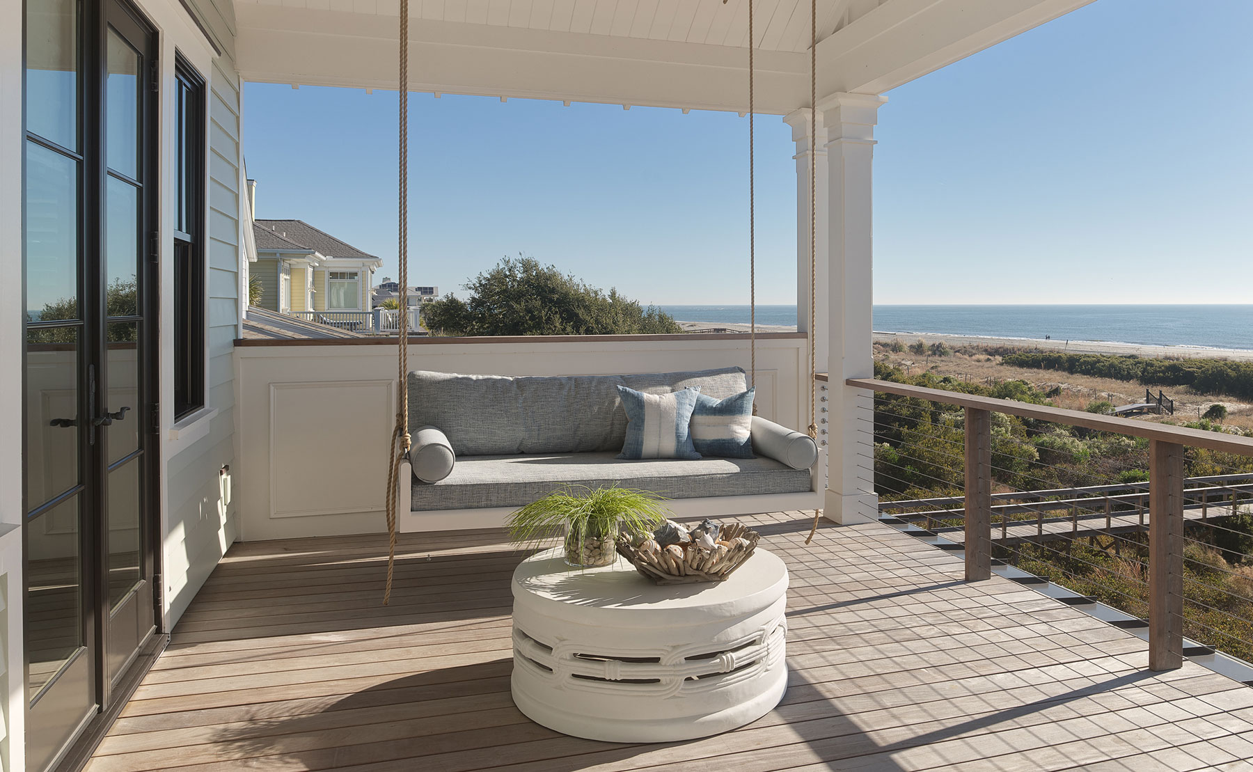 Covered porch with swinging day bed with ocean views