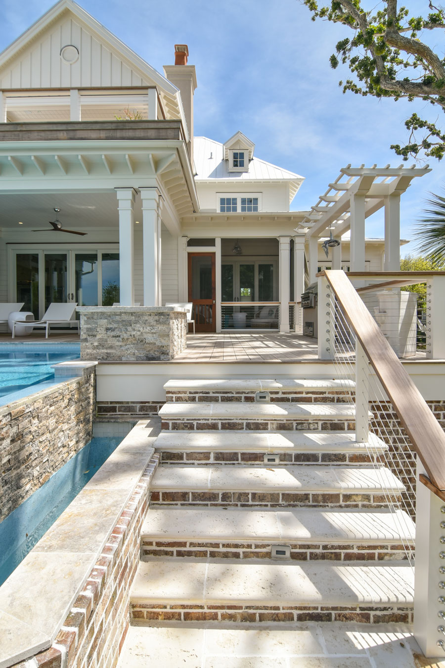 Elevated Pool with brick stairs to backyard