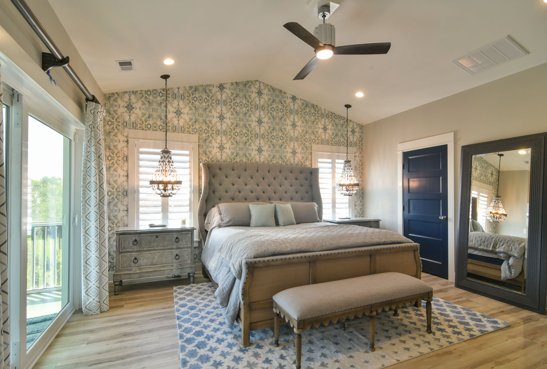 Master Suite with wallpaper accent wall and vaulted ceiling