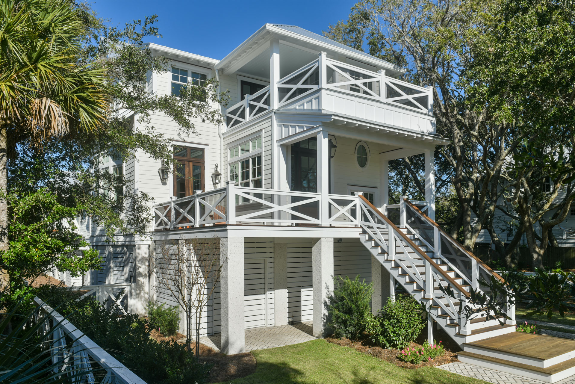 Newly-built coastal, low country home with elevated front porch and balacony/deck above
