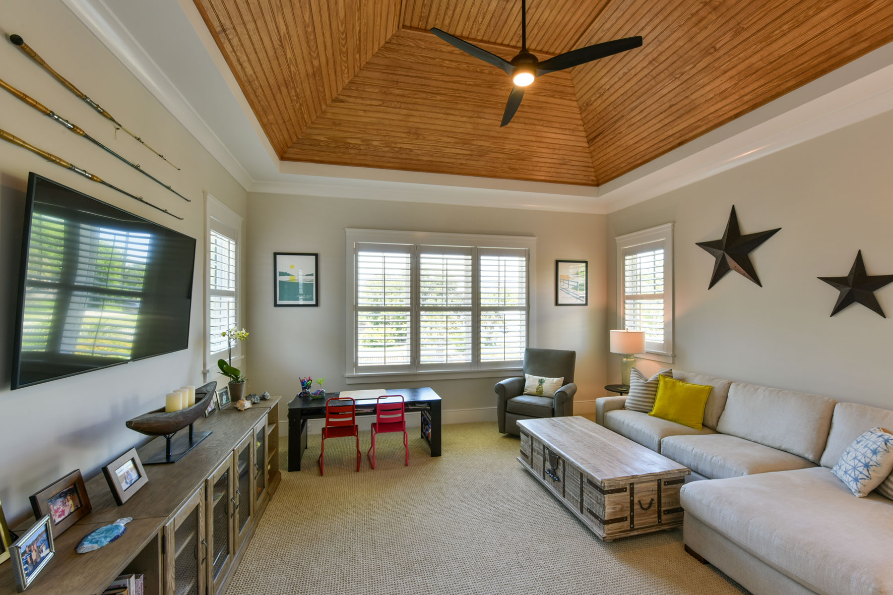 Kids family room with vaulted, wood ceiling