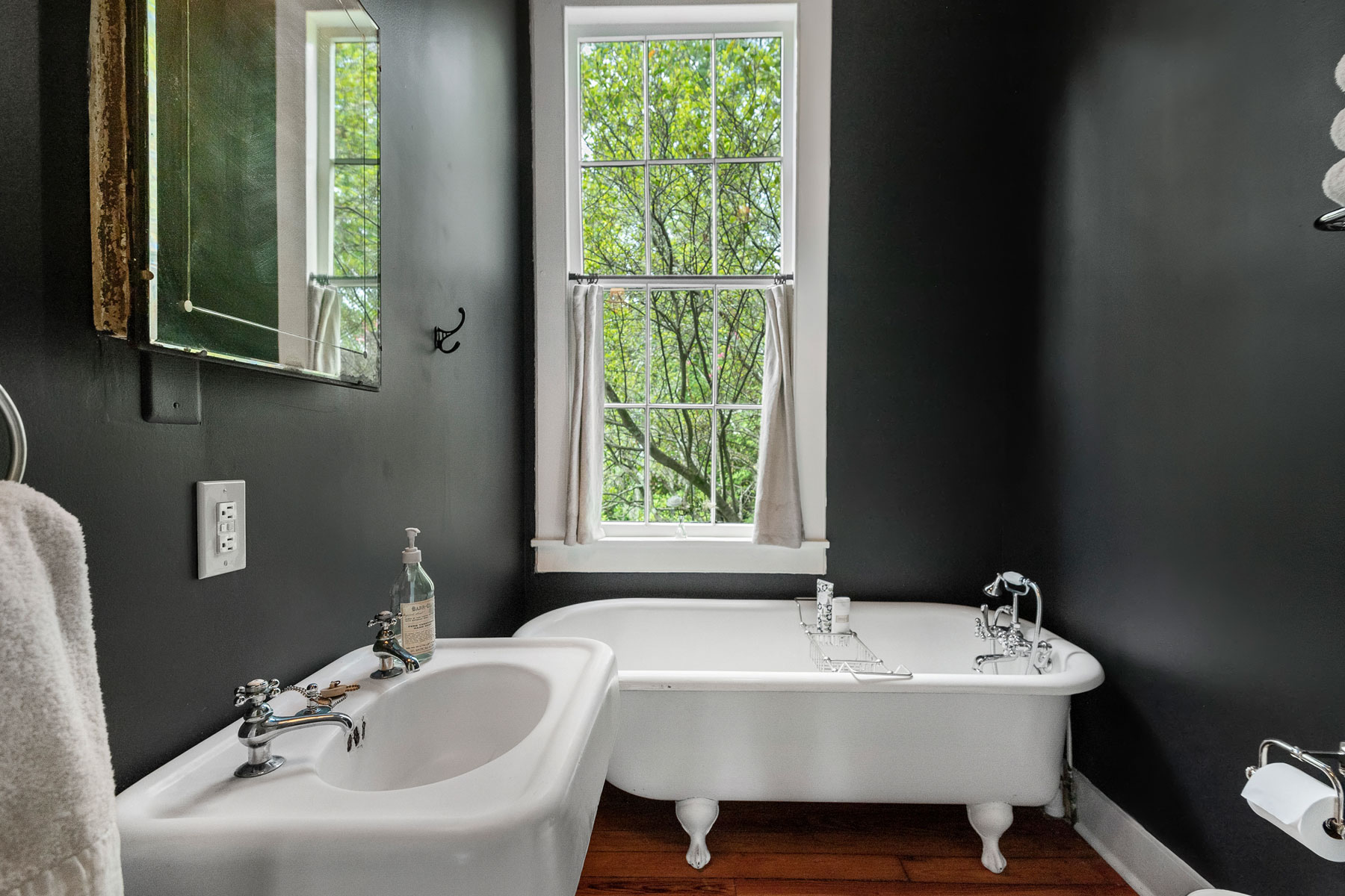 Vintage bath renovation with freestanding claw foot tub and pedestal sink