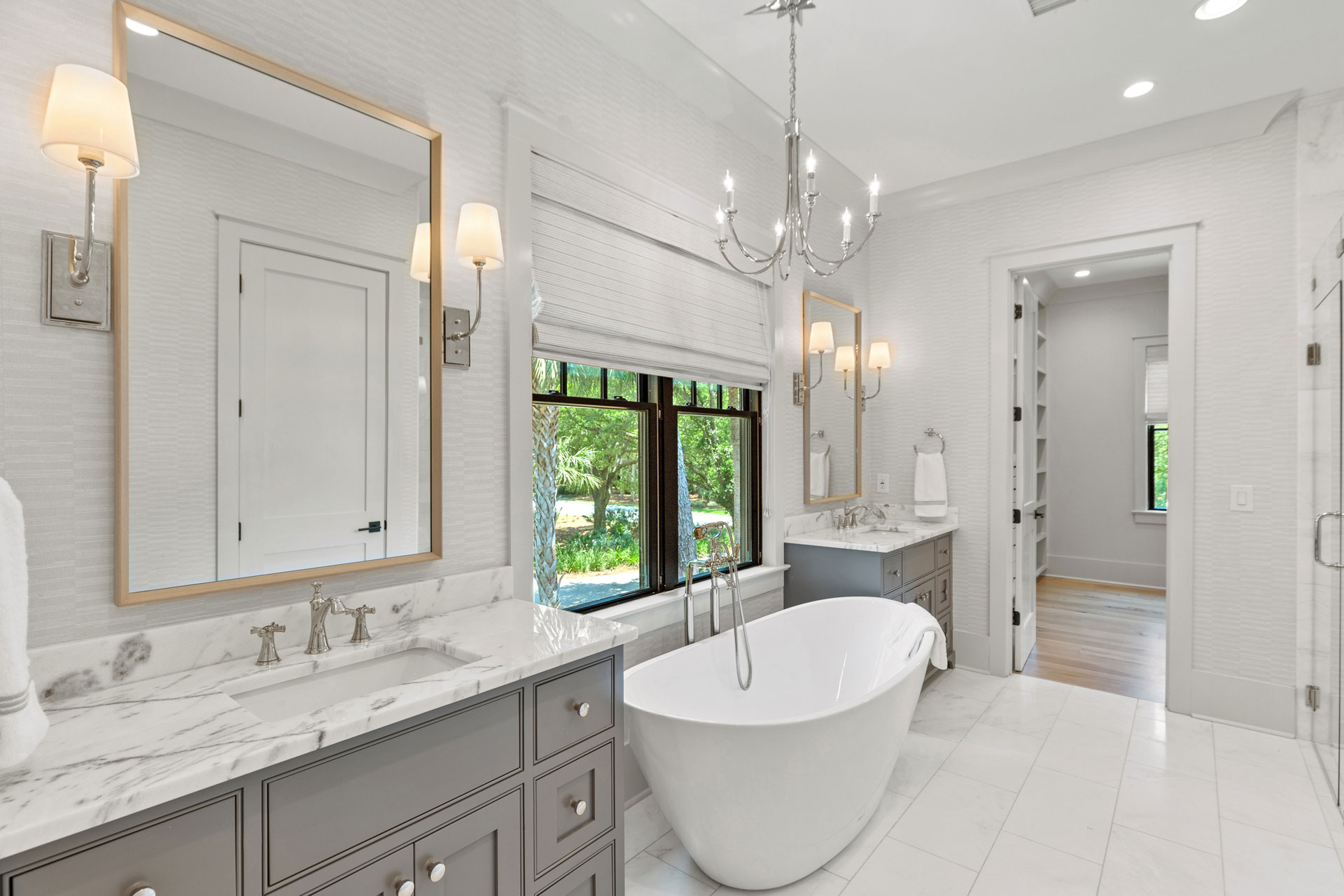 Master bath with coastal glamour, gray cabinets, separate tub