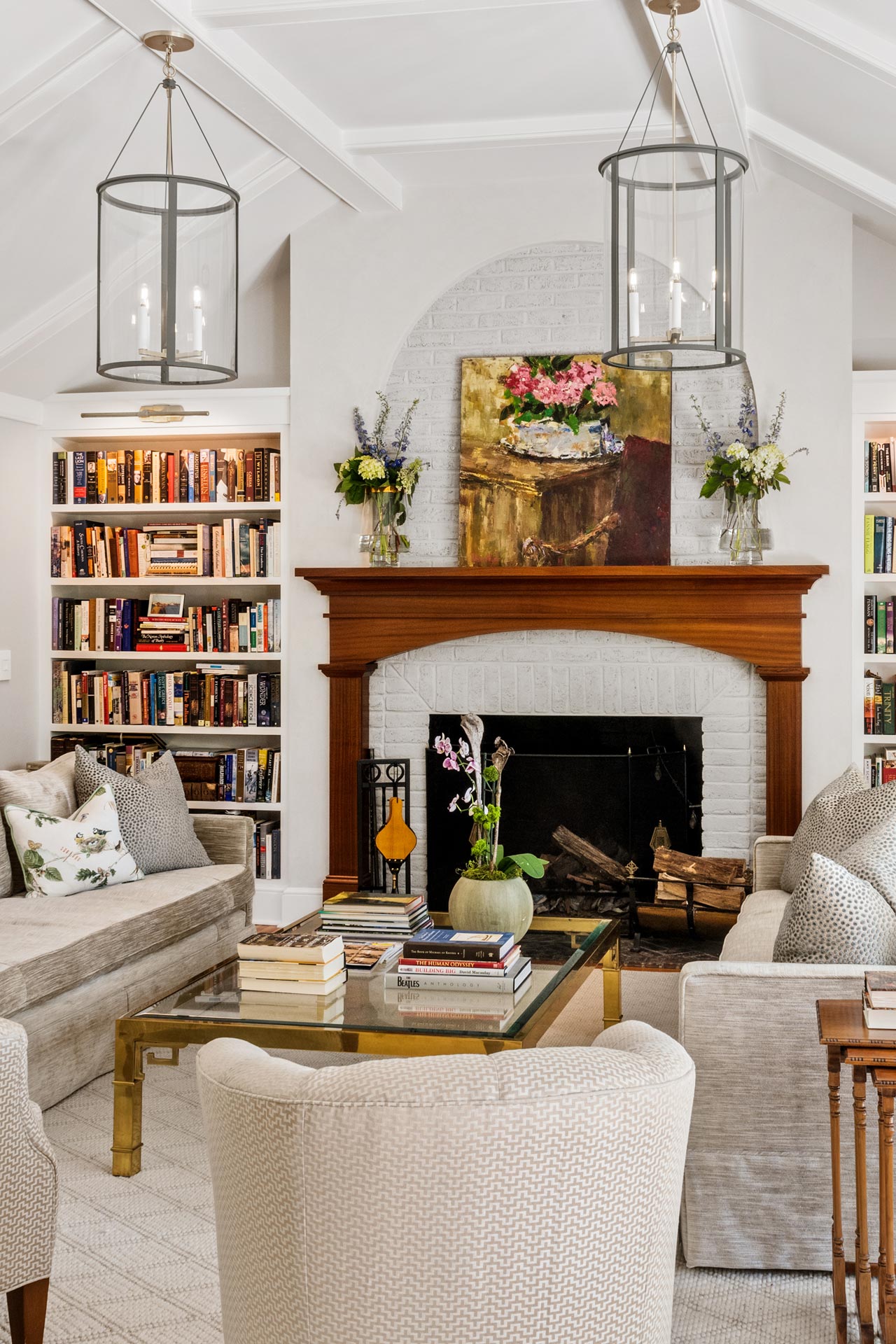 White brick fireplace with wood mantel and surround and built-in bookcases
