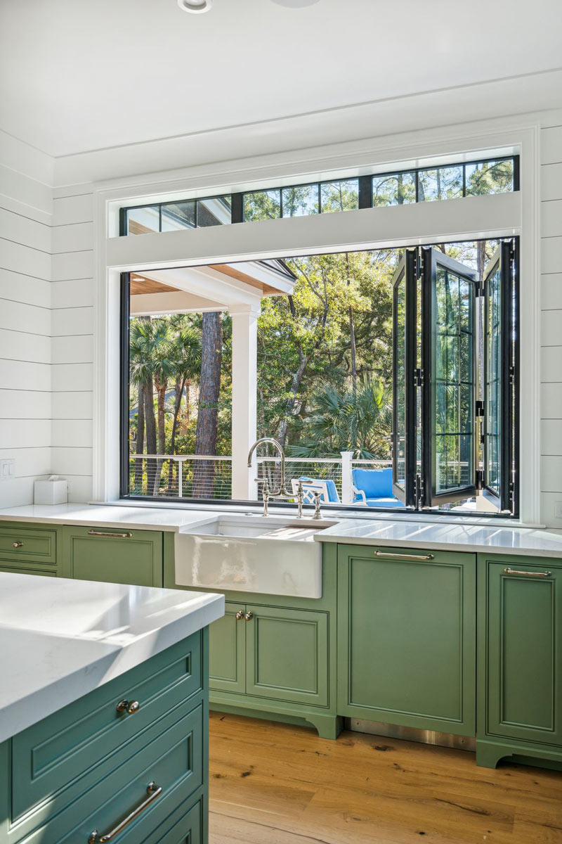 Accordion window at kitchen sink that opens countertop to outside.